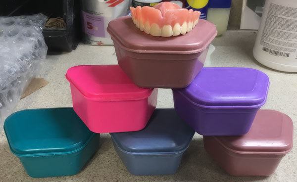 denture on a pyramid of denture boxes