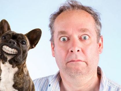 shocked man with his denture wearing dog