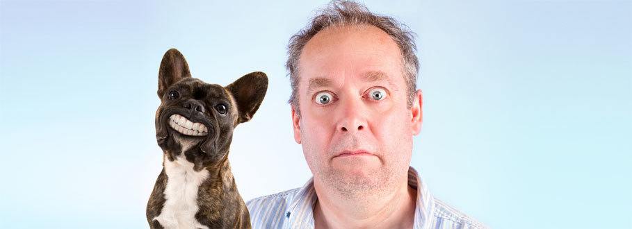 shocked man with his denture wearing dog