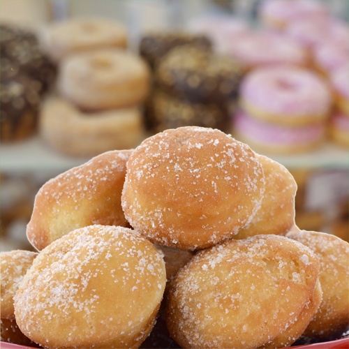 doughnut holes in front of a bakery display