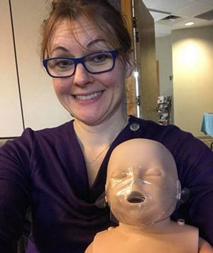 Dr. Lake holding her CPR dummy