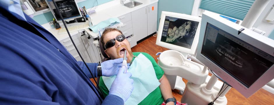 Dr. Drews taking digital imagery of a patient's teeth
