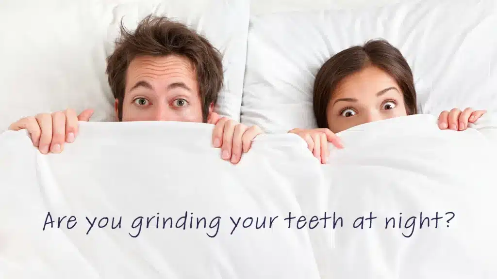 silly couple in bed with the covers pulled up over their mouths