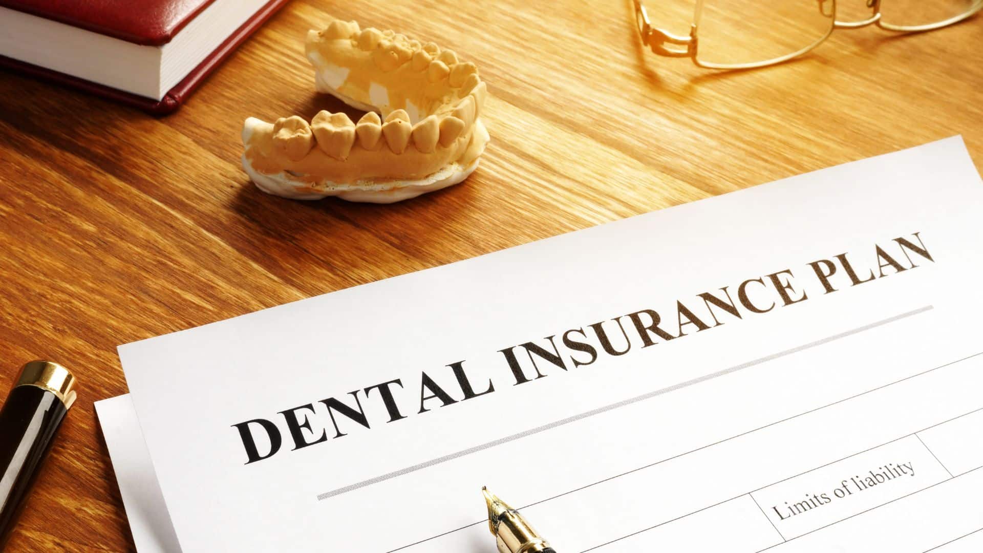 dental insurance plan paperwork sitting on top of a desk