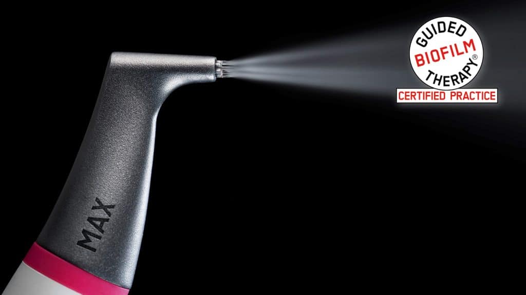 EMS AIRFLOW handpiece spraying fine powder stream with Guided Biofilm Therapy Certified Practice badge