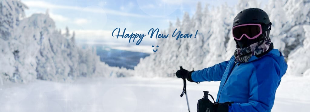 Dr. Hena Patel ready to ski down a mountain with the words happy new year and a smiley face written across the background