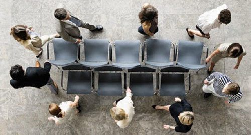 aerial view of grown ups playing a game of musical chairs