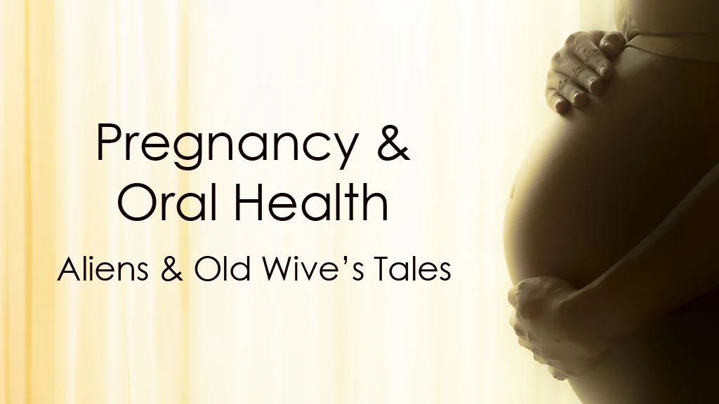 pregnant woman holding her belly with the words pregnancy and oral health highlighted