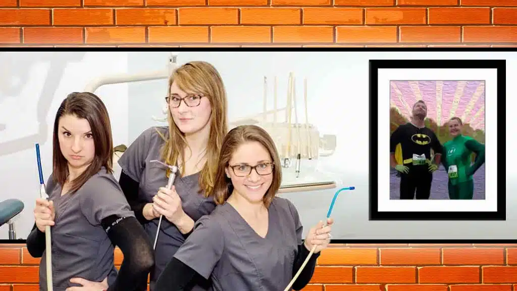 kayla, renee, and chelsea in the office with a painting of the dentists on the wall