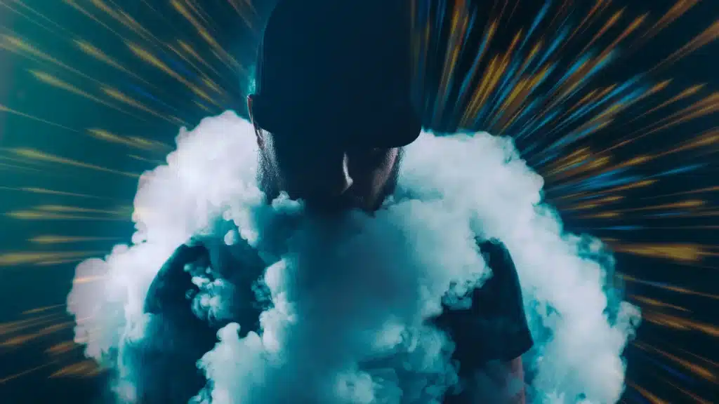 young man on a dark background surrounded by smoke and exploding lines in the background